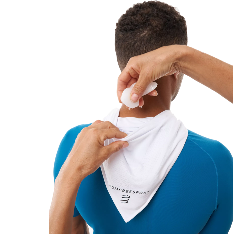 Up & Running Compressport white cooling bandana with ice pocket being filled by hand on a runner's neck