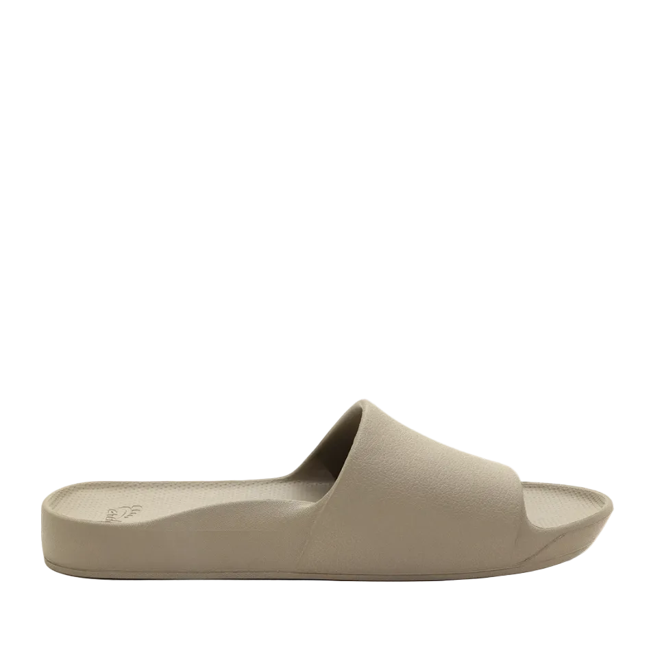 A single taupe-colored slide sandal shown from a side profile view against a solid white background.