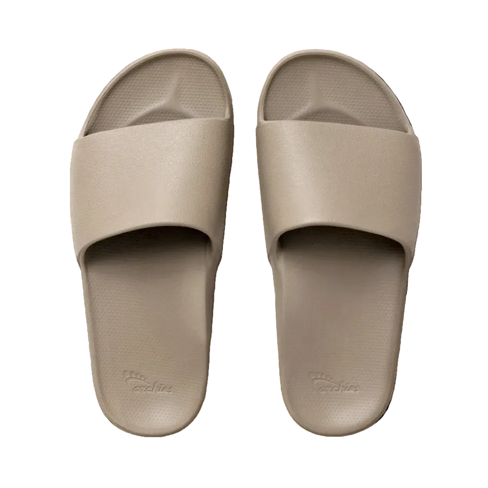 Pair of beige slides on a white background