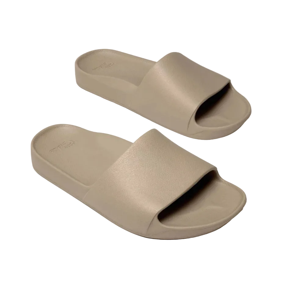 Pair of beige slides on a white background