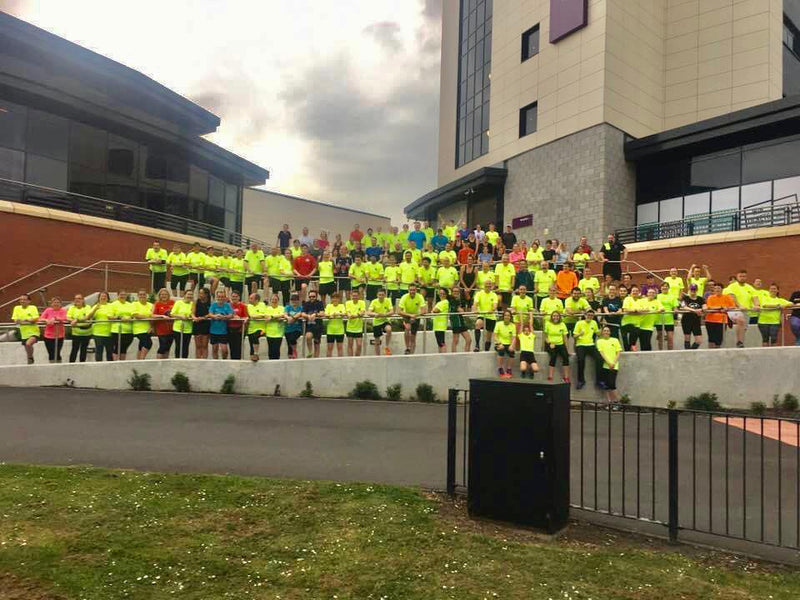 running group together for a group photo whilst on a run together from up and running