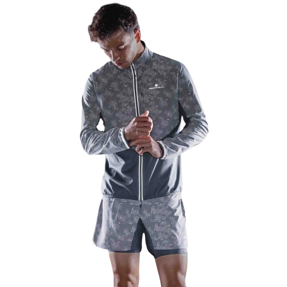 Up & Running Ronhill men's black reflective tech running jacket with full zip and high collar on a male runner