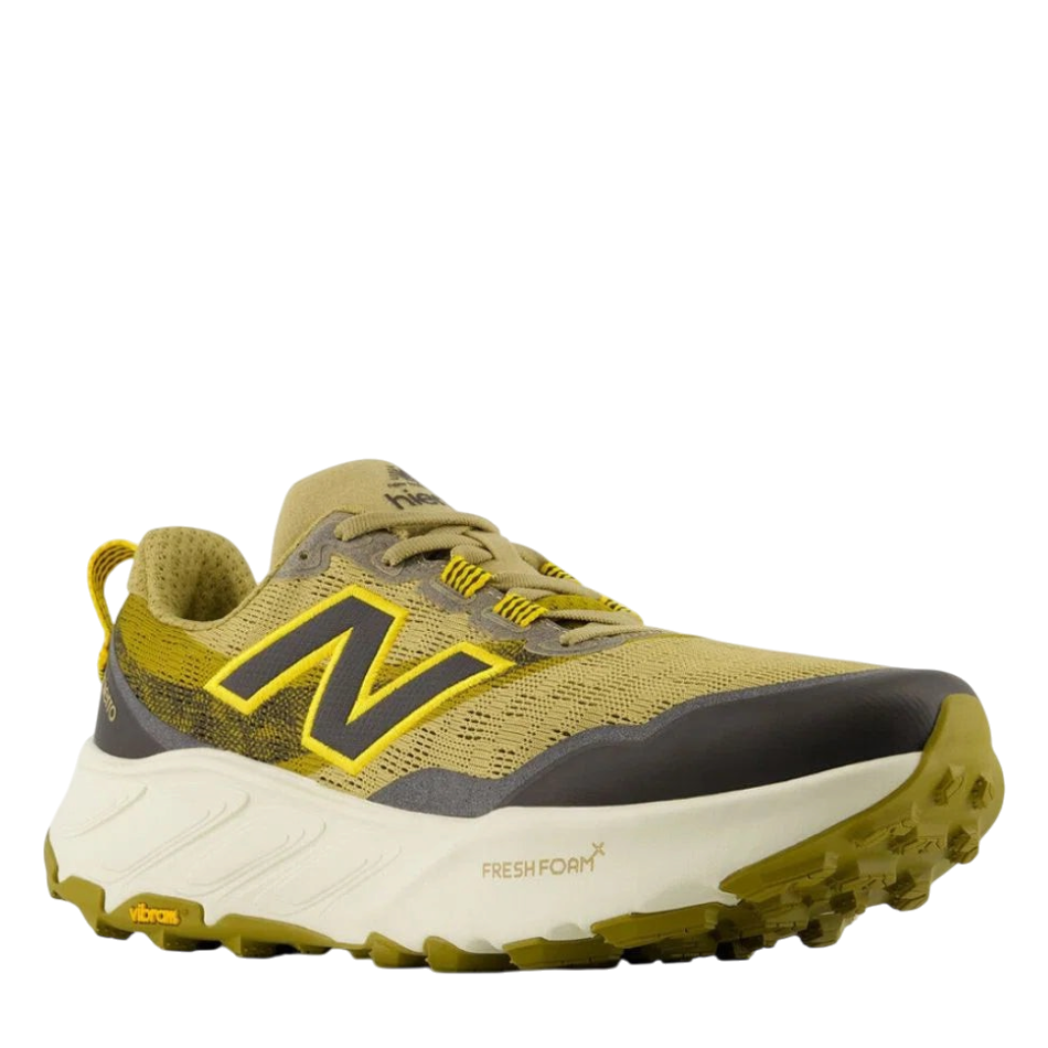 Up & Running New Balance Hierro v9 trail running shoes in quicksand, orange, and black with a Vibram lugged outsole.