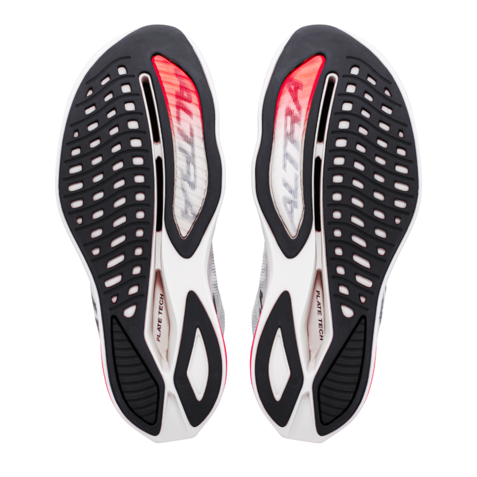 Up & Running Altra Vanish Carbon 3 women's running shoes showing the white, black, and fiery coral rubber outsoles.