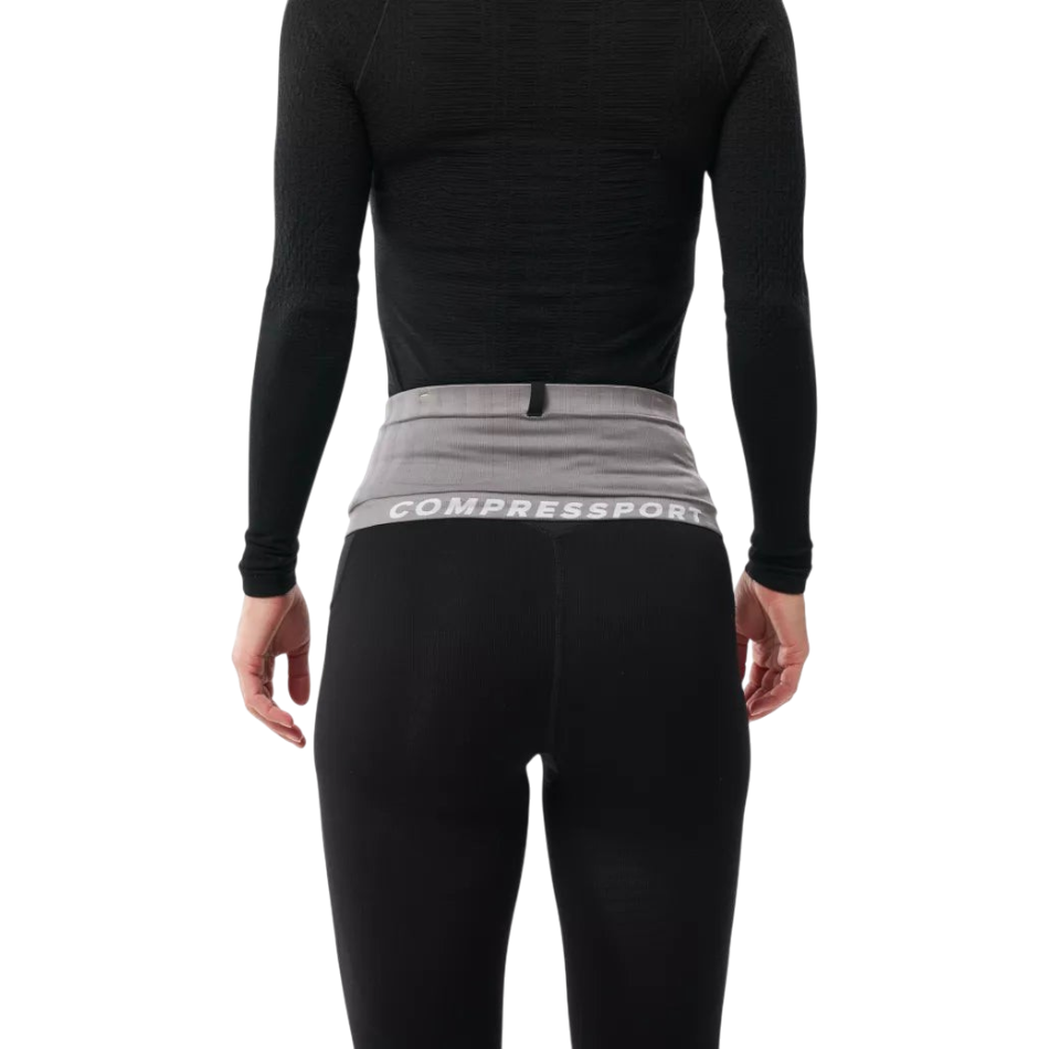 Up & Running Compressport Free Belt 2.0 in grey worn around the waist over black running gear for secure storage