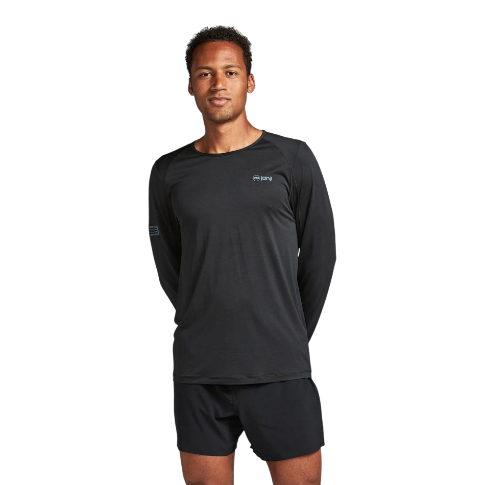 Up & Running model wearing a black Janji Men's Run All Day long sleeve performance shirt for running.