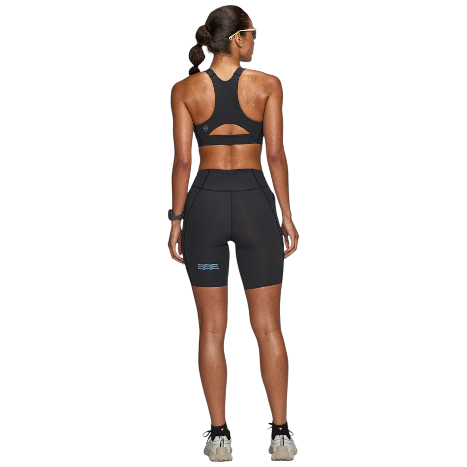 Up & Running Janji women's 7-inch Pace running shorts in midnight black, shown from the back on a female athlete.