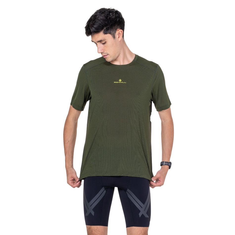 Up & Running Ronhill men's tech short sleeved tee in dark green kelp with yellow logo detail worn by a male runner.