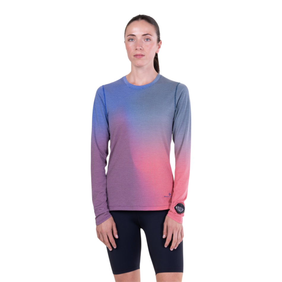 Up & Running model wearing a blue and violet Ronhill long-sleeved running tee with a watch window on the sleeve